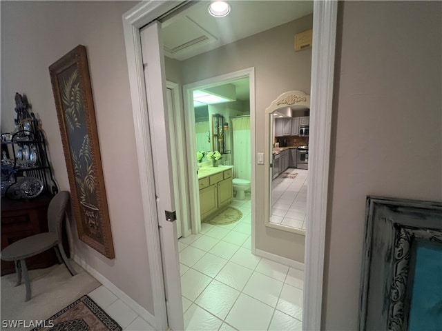 bathroom featuring vanity, tile patterned flooring, and toilet