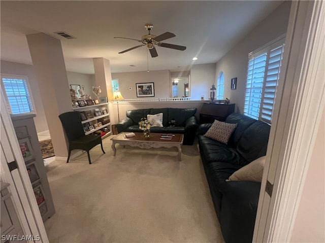 living room with light colored carpet, plenty of natural light, and ceiling fan