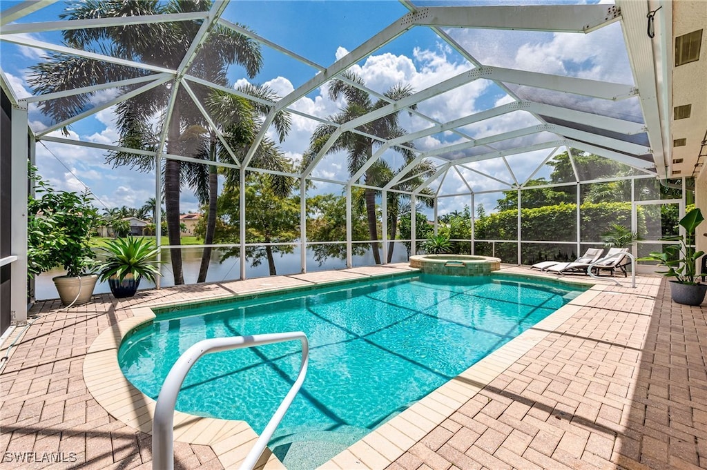 view of pool with a patio, an in ground hot tub, and a lanai