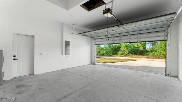 garage with electric panel and a garage door opener