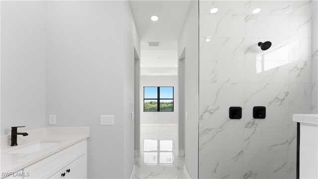 bathroom featuring vanity and a tile shower