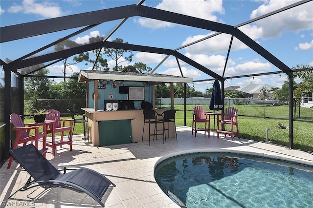 view of patio / terrace featuring exterior bar and glass enclosure