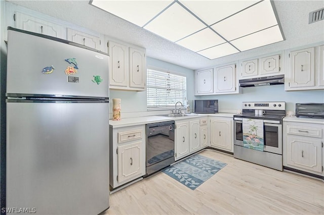 kitchen featuring sink, white cabinetry, black appliances, a textured ceiling, and light wood-type flooring