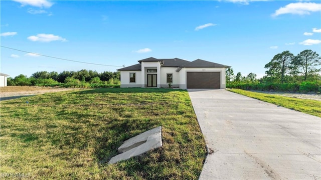 view of front of house with a front lawn and a garage