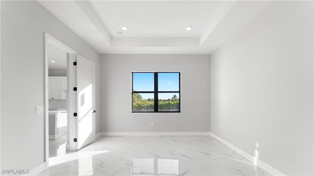 empty room featuring a tray ceiling