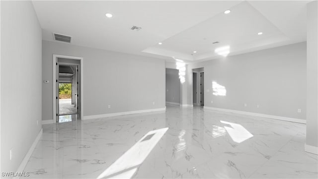 empty room featuring a tray ceiling