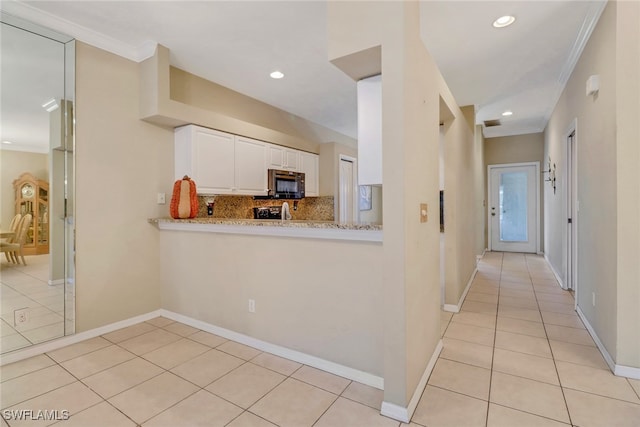 kitchen featuring tasteful backsplash, light stone counters, ornamental molding, light tile patterned floors, and white cabinets