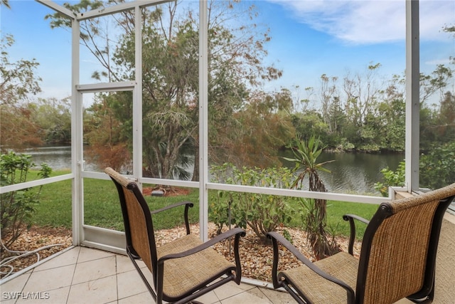 unfurnished sunroom featuring a water view