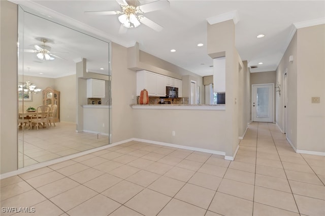 interior space featuring ceiling fan with notable chandelier, light tile patterned floors, and crown molding