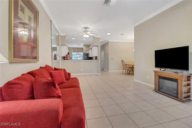 living room with ceiling fan, light tile patterned floors, and ornamental molding