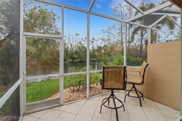 unfurnished sunroom featuring a water view