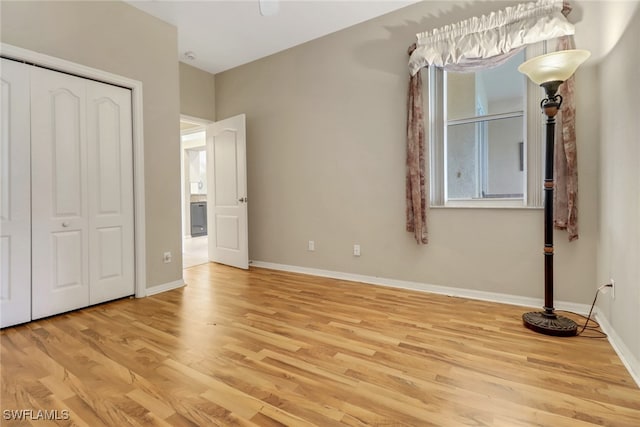 unfurnished bedroom featuring light hardwood / wood-style floors and a closet