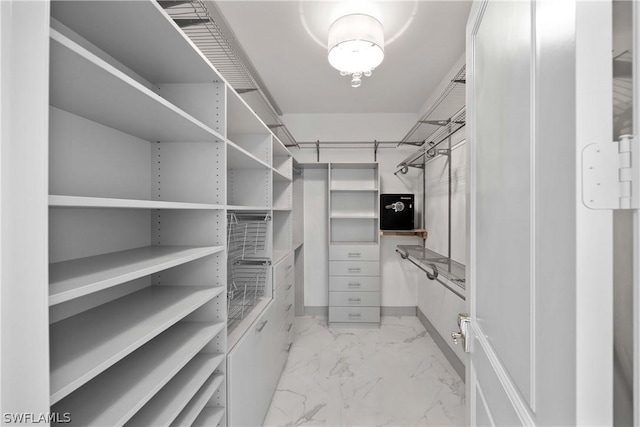 spacious closet with marble finish floor
