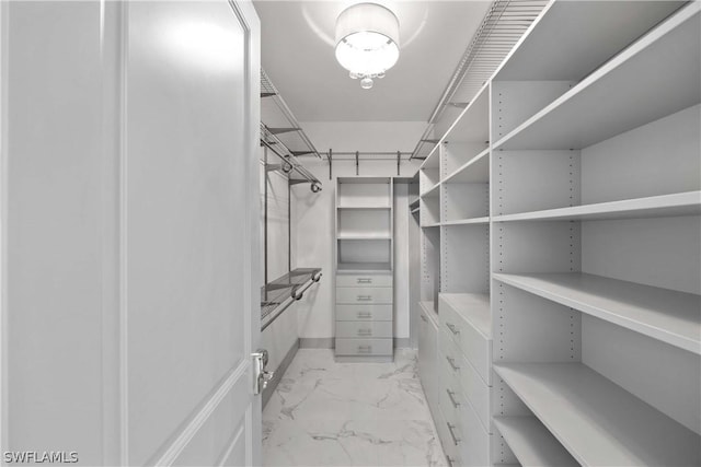 spacious closet with marble finish floor