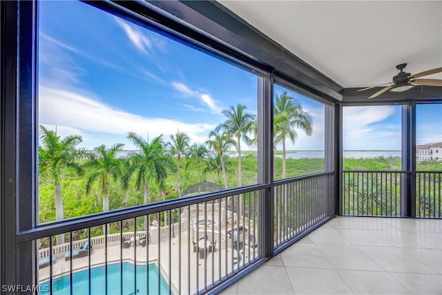 unfurnished sunroom featuring ceiling fan