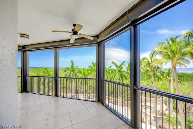 unfurnished sunroom featuring ceiling fan