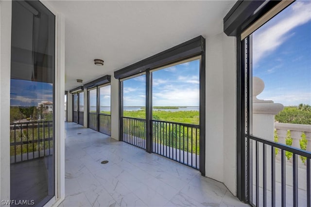 unfurnished sunroom featuring a wealth of natural light