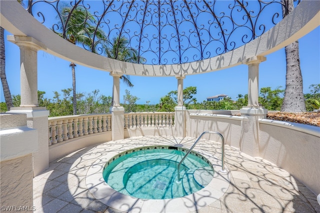 view of patio featuring an in ground hot tub