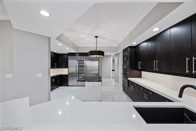 kitchen featuring marble finish floor, recessed lighting, a sink, dark cabinetry, and built in fridge