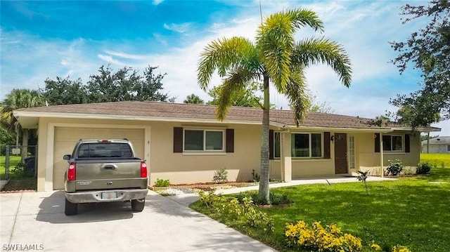 ranch-style home with a garage and a front lawn