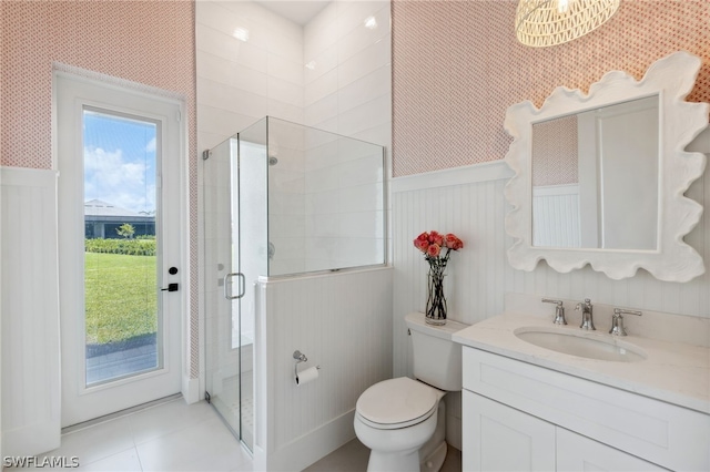 bathroom with wainscoting, wallpapered walls, and a shower stall