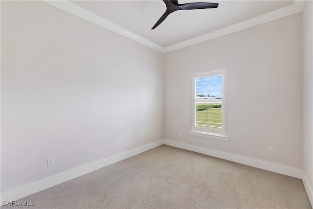 carpeted spare room with ornamental molding and ceiling fan