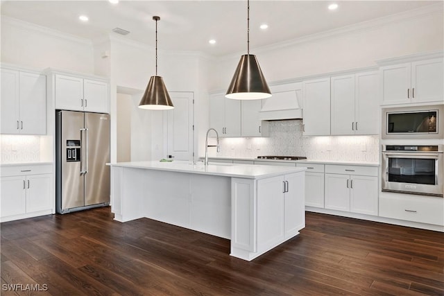 kitchen with light countertops, dark wood-style flooring, appliances with stainless steel finishes, and a sink