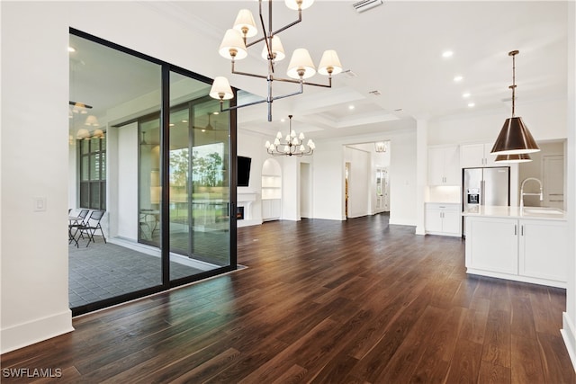 interior space featuring ornamental molding, dark hardwood / wood-style floors, a chandelier, and sink