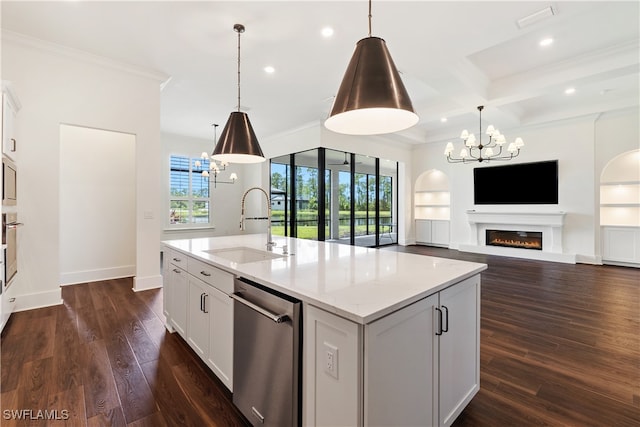 kitchen featuring appliances with stainless steel finishes, sink, coffered ceiling, a center island with sink, and beam ceiling