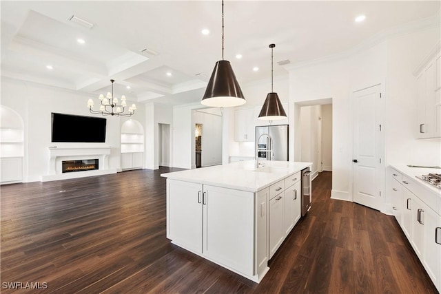 kitchen featuring a kitchen island with sink, built in shelves, coffered ceiling, and beamed ceiling