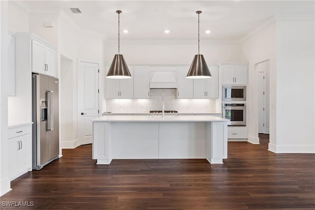 kitchen featuring tasteful backsplash, appliances with stainless steel finishes, light countertops, and premium range hood