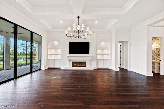 unfurnished living room with an inviting chandelier, beam ceiling, dark hardwood / wood-style floors, coffered ceiling, and built in shelves