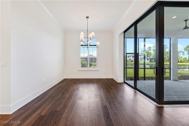 unfurnished dining area with ceiling fan with notable chandelier, wood finished floors, baseboards, and ornamental molding