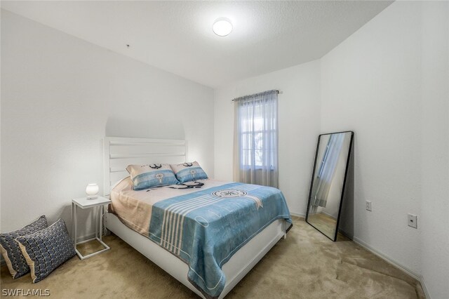 bedroom featuring light carpet