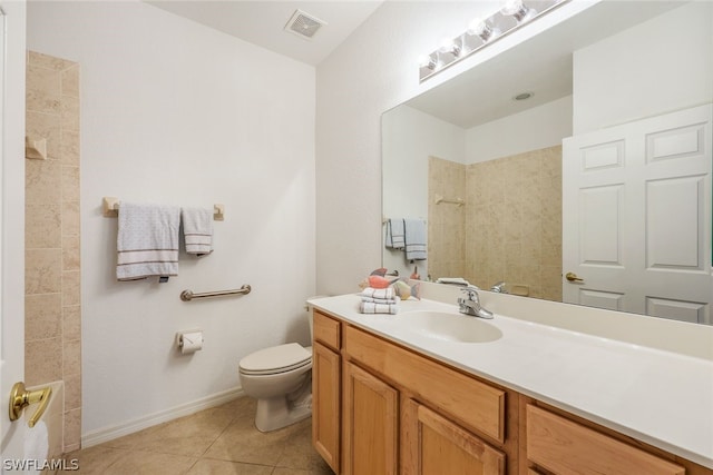 bathroom with tile patterned flooring, vanity, and toilet