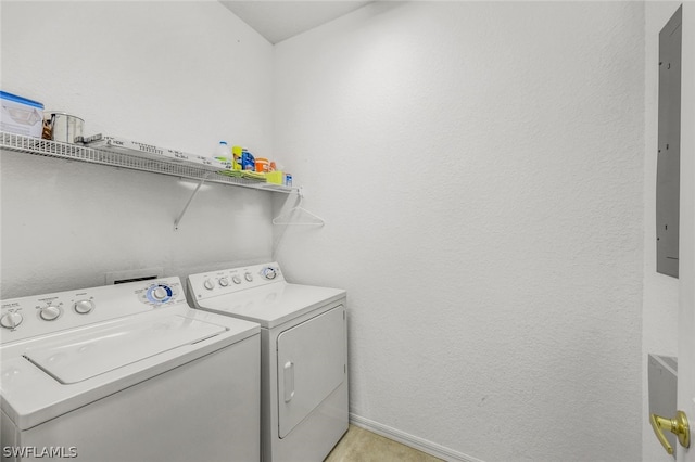 clothes washing area with washing machine and dryer