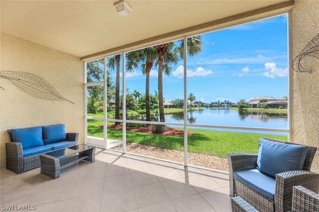 sunroom / solarium featuring a water view