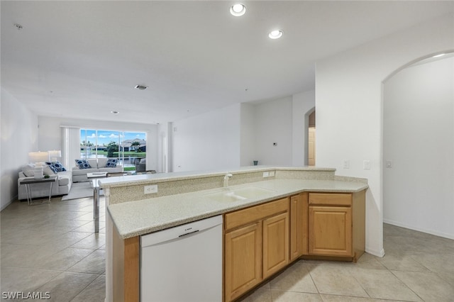 kitchen with dishwasher, sink, and light tile patterned floors