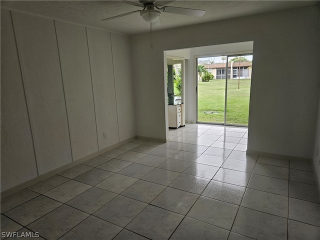 spare room with light tile patterned flooring and ceiling fan