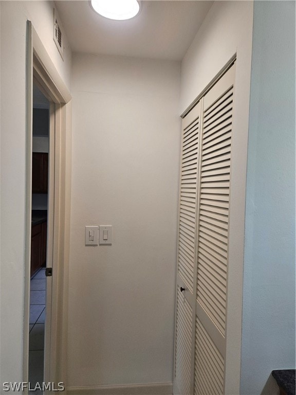 hallway featuring tile patterned floors