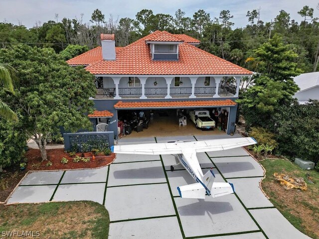 view of front of property with a balcony and a garage