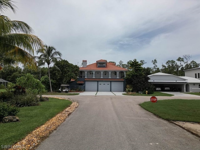 mediterranean / spanish-style house with a garage and a front yard