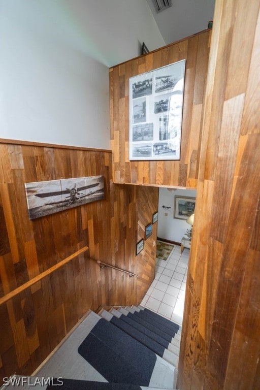 interior space featuring tile patterned floors and wood walls