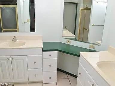 bathroom featuring tile patterned flooring and vanity