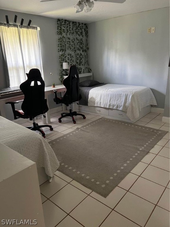 tiled bedroom featuring ceiling fan