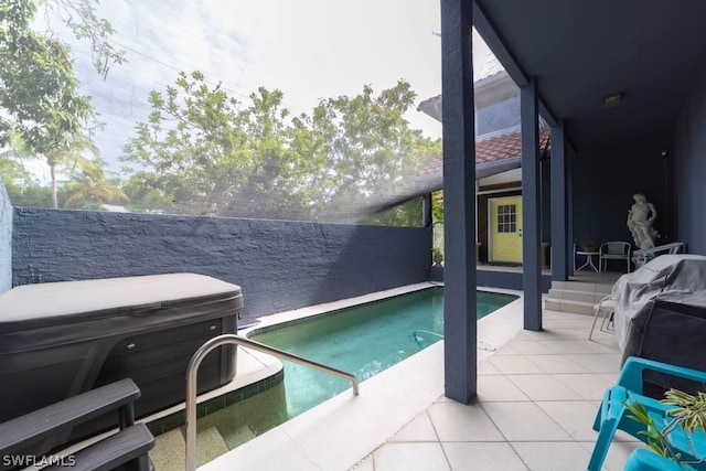 view of pool featuring a patio area and a hot tub