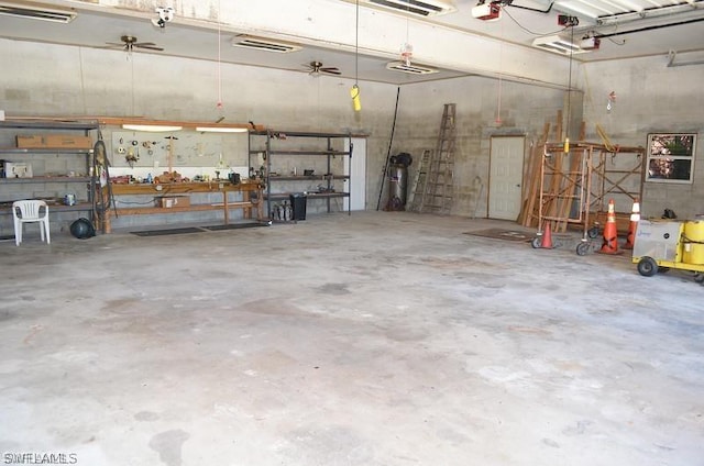 garage with ceiling fan, a workshop area, and a garage door opener