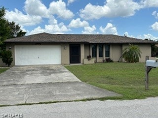 ranch-style house with a garage and a front lawn