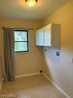 laundry area featuring cabinets, light tile patterned floors, hookup for an electric dryer, and washer hookup