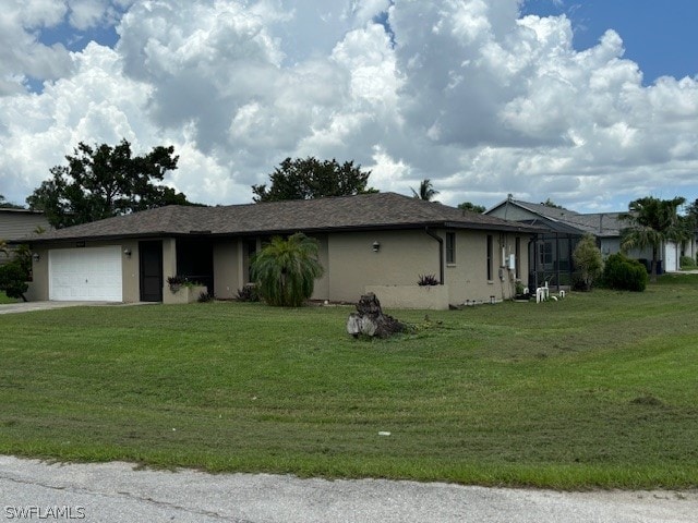 view of front of home with a garage and a front lawn